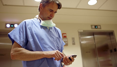 A doctor accessing secure patient data on his mobile device