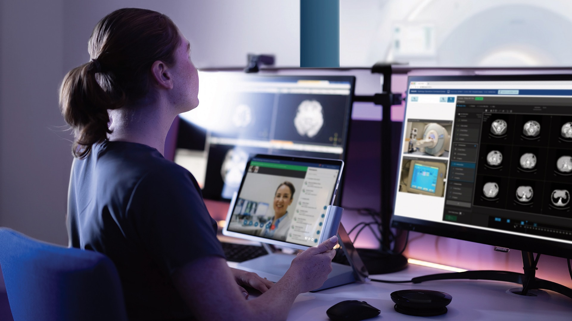 A radiology technologist receiving virtual guidance from a colleague in a central hub while acquiring a scan